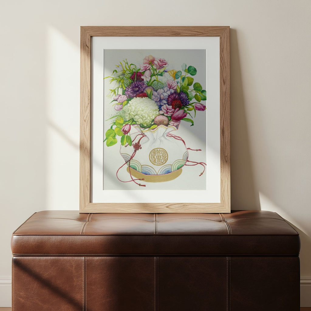 Framed art print of a Korean coin pouch holding a bouquet of flowers, which symbolizes celebrates luck, good health, and fortune, on a wall above a brown leather bench.