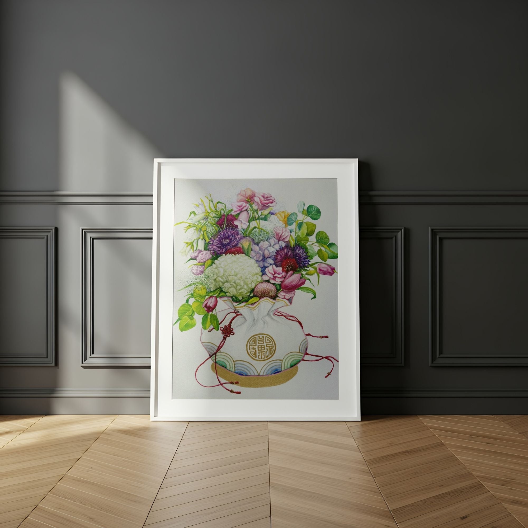 Framed wall art of a Korean coin pouch with a bouquet of flowers, which symbolizes celebrates luck, good health, and fortune, on a dark wall.