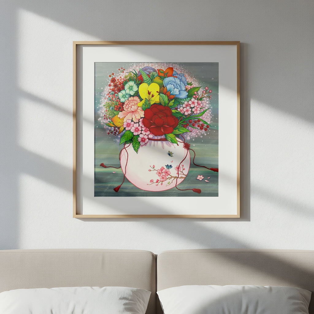 Elegant art print that draws from Korean folk art heritage, weaving together blossoms and traditional motifs that celebrate harmony, wellness, and good fortune, on a wall above a sofa.